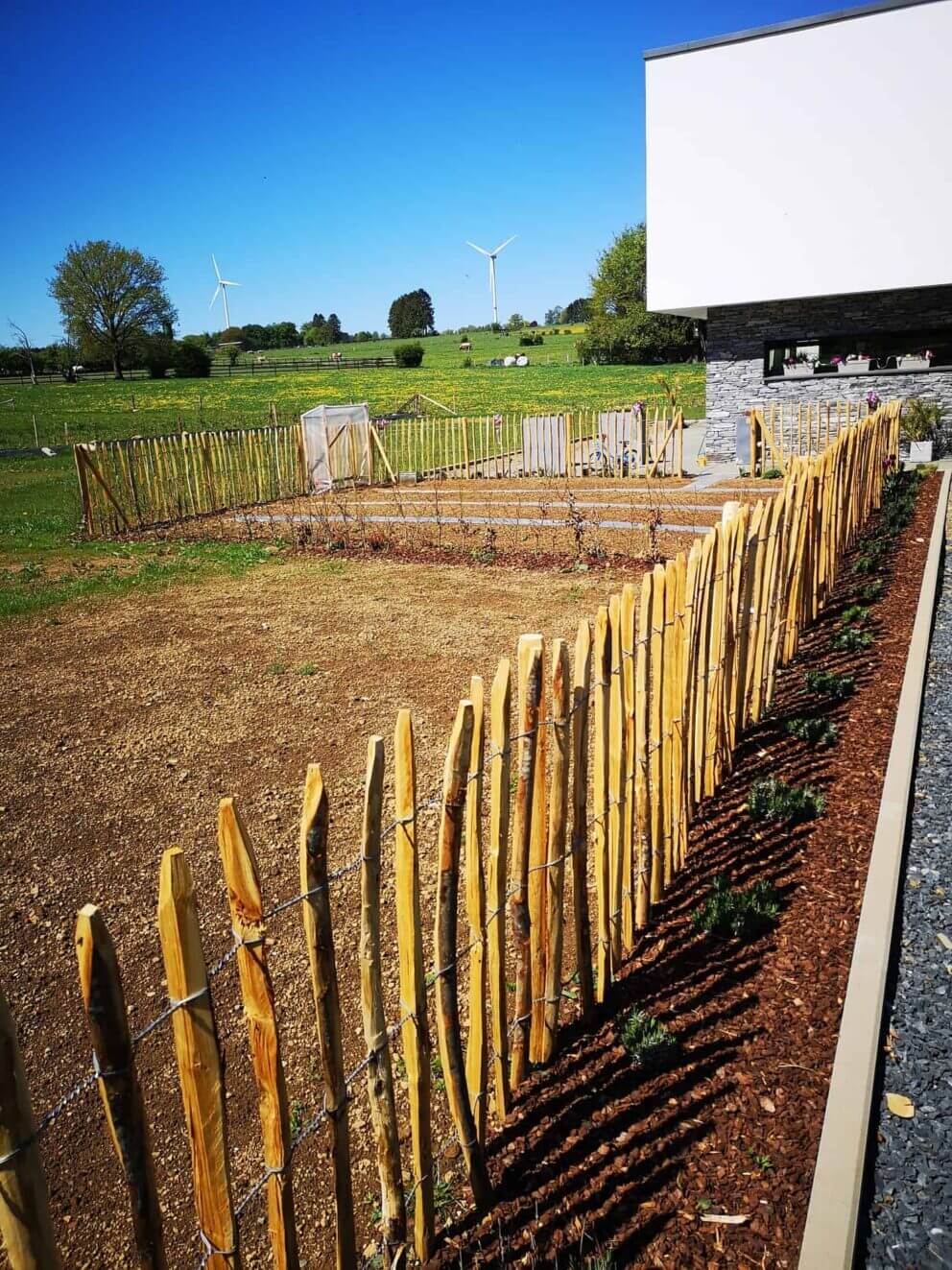 Clôture ganivielle française en bois de châtaignier de 100 cm de hauteur et avec un espacement de 8 cm. entre les lattes. Clôture autour du potager.