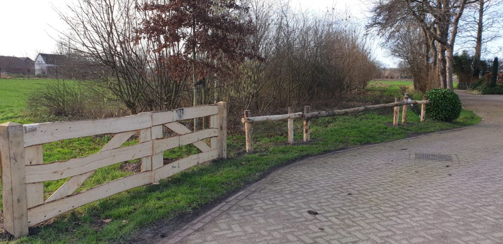 Dubbele kastenje boerenlandhek van 205 cm breed en 110 cm hoog met kastanje schaaldelen. Deze poort staat aan het begin van de wei als toegangspoort.