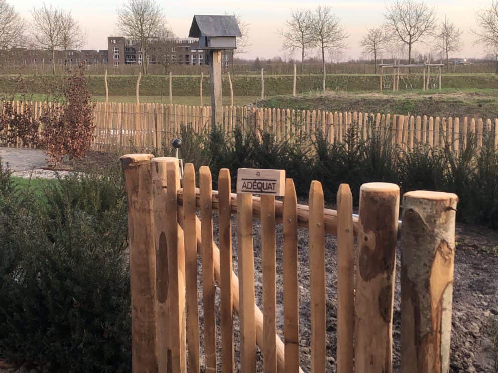 Franse rondhoutpoort van 80 cm hoog en 80 cm breed als doorgang in een tuin.