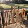 Franse rondhoutpoort van 80 cm hoog en 150 cm breed als toegang naar een tuin.